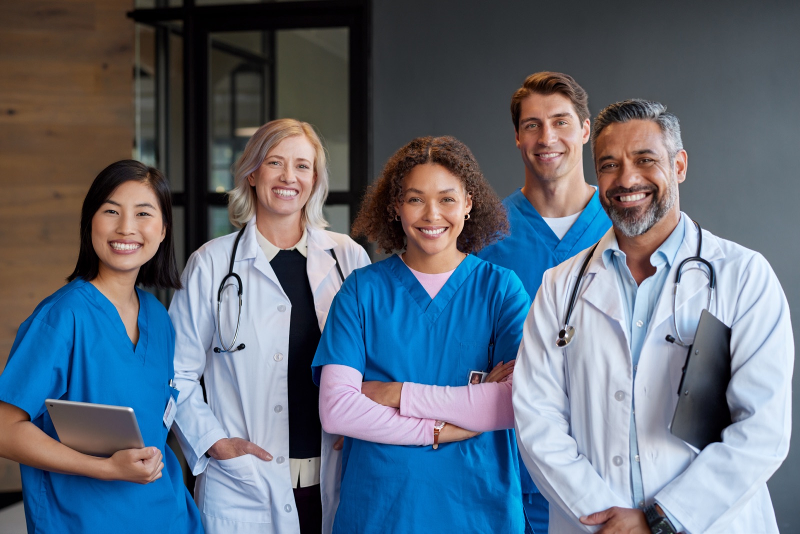 A team of smiling physicians and clinicians